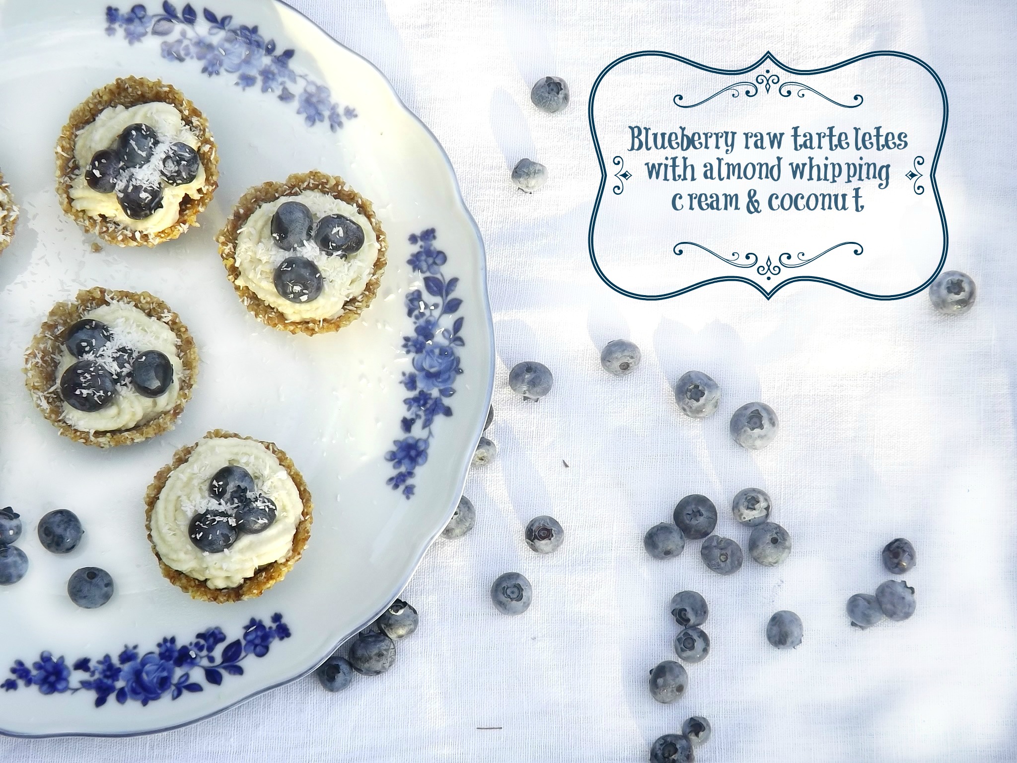 Raw mini tarts with almond whipping cream and blueberries